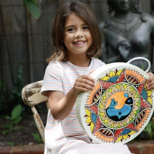 Child holding Ocean Drum