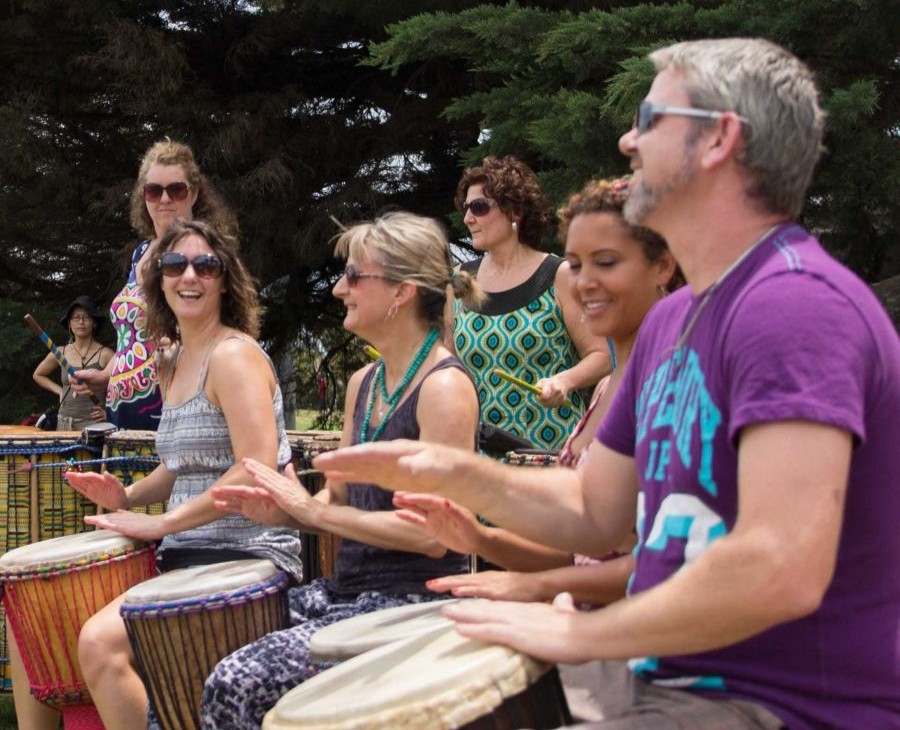 a group of drummers playing the djembe in the park in Melbourne