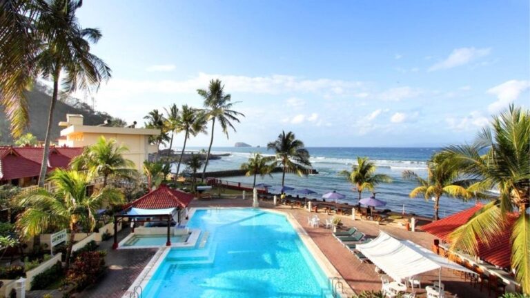 Oceanfront resort venue for African Drumming’s Bali Drum Camp, featuring a pool, palm trees, and views of the sea.
