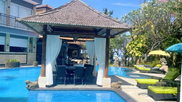 Oceanfront dining area at the venue for African Drumming’s Bali Drum Camp, overlooking the sea and pool at sunset.