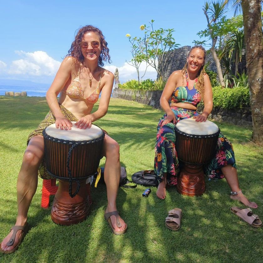 Participants drumming at the Bali Drum and Dance Retreat, enjoying the rhythm and cultural experience in a tropical setting.