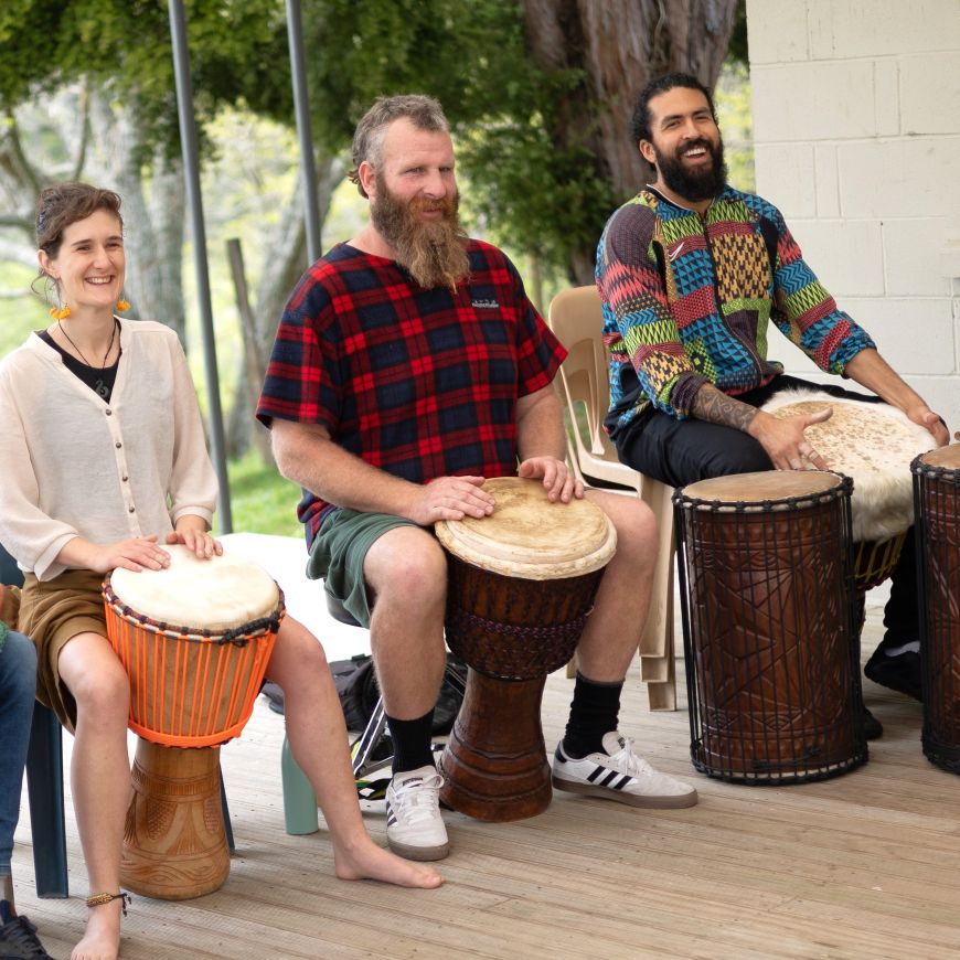 Participants at the NZ Drum and Dance Retreat, enjoying drumming together in a relaxed, community setting.