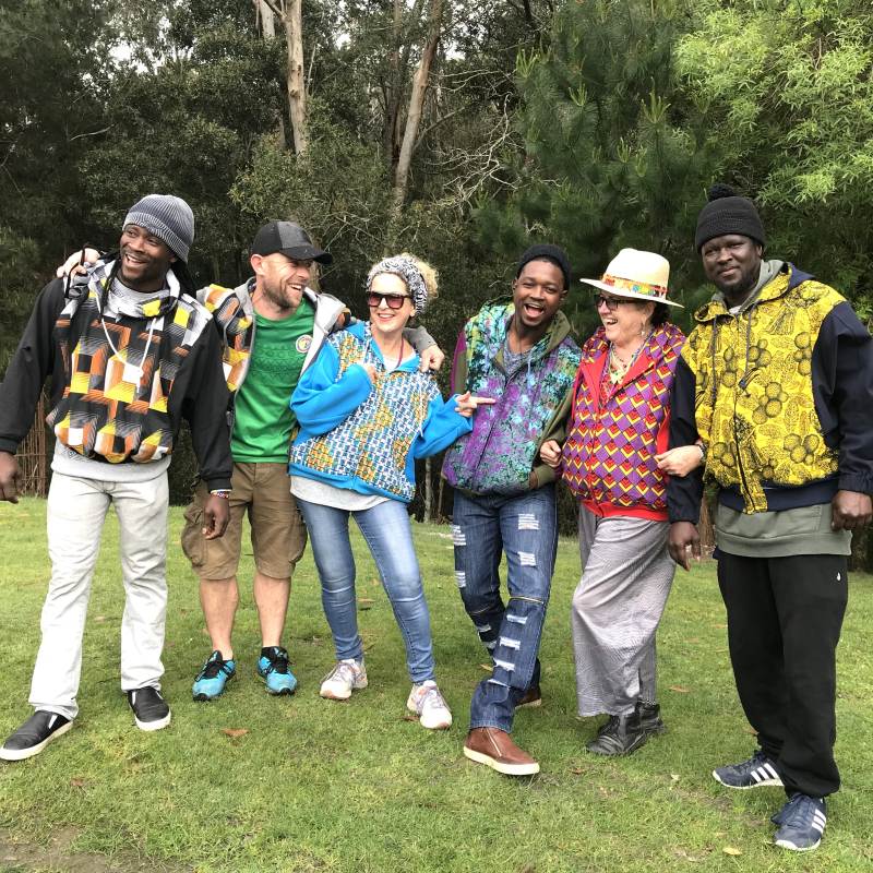 Teachers and participants enjoying the Spring Drum and Dance Retreat in Victoria, dressed in vibrant African print jackets and sharing a moment of celebration.