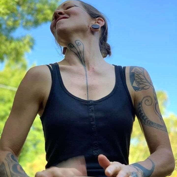 Person playing djembe outdoors during a drumming session in Melbourne