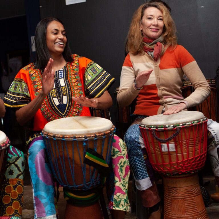 2 female drumming students performing at tribalism in melbourne