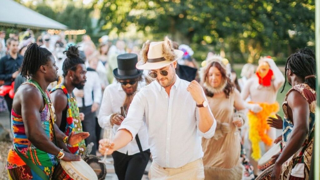 Cultural wedding celebration enhanced by African performers with African drumming.
