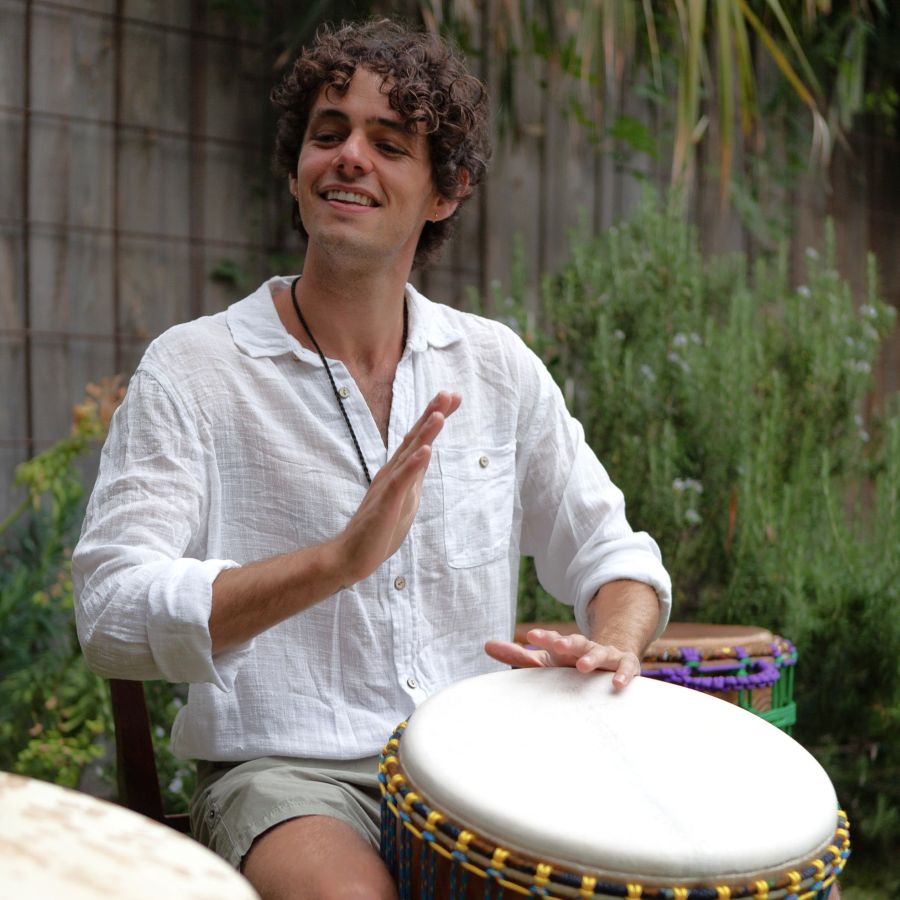 Person playing djembe during a private drumming lesson in Melbourne