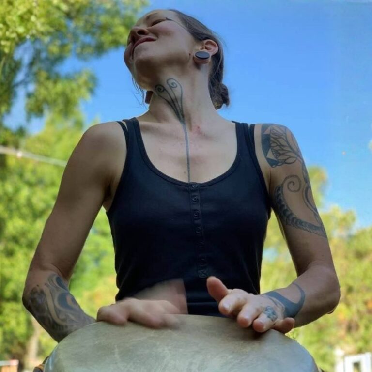 advanced drumming teacher plays african djembe in park