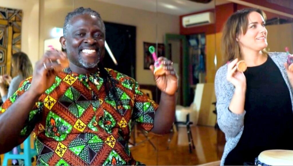 two teachers playing shakers and smiling at the african drumming facilitator training workshop in melbourne