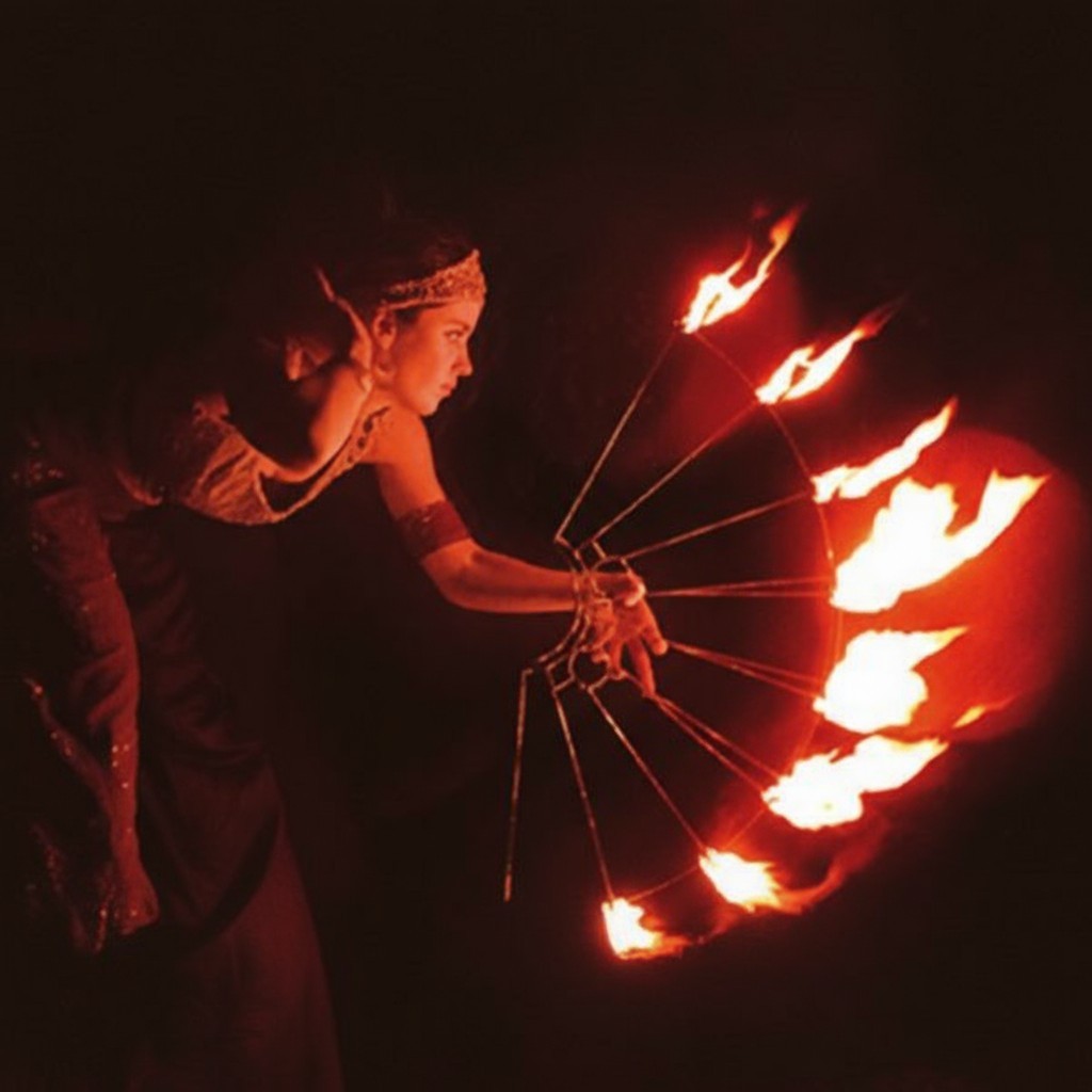 a female fire twirler performing in the dark