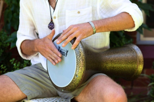 a man playing middle eastern darbuka drum