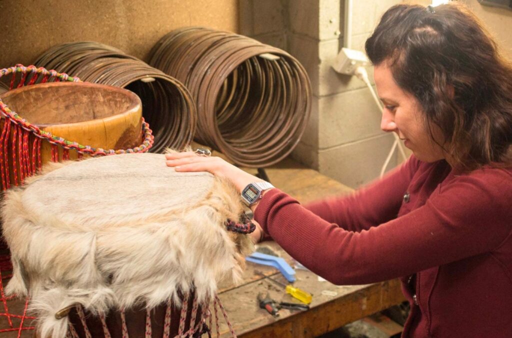 reskin of a djembe in a Melbourne workshop for drum making and repairs.