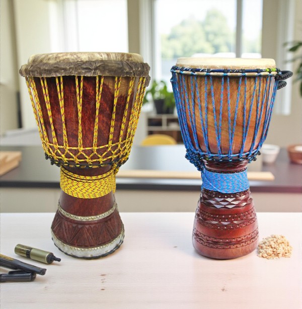 Two Master Series djembes with yellow and blue rope tuning, handcrafted from West African hardwoods.