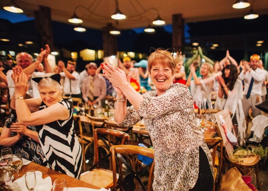 Guests enjoying interactive drumming at a Melbourne birthday party, clapping along to the music.