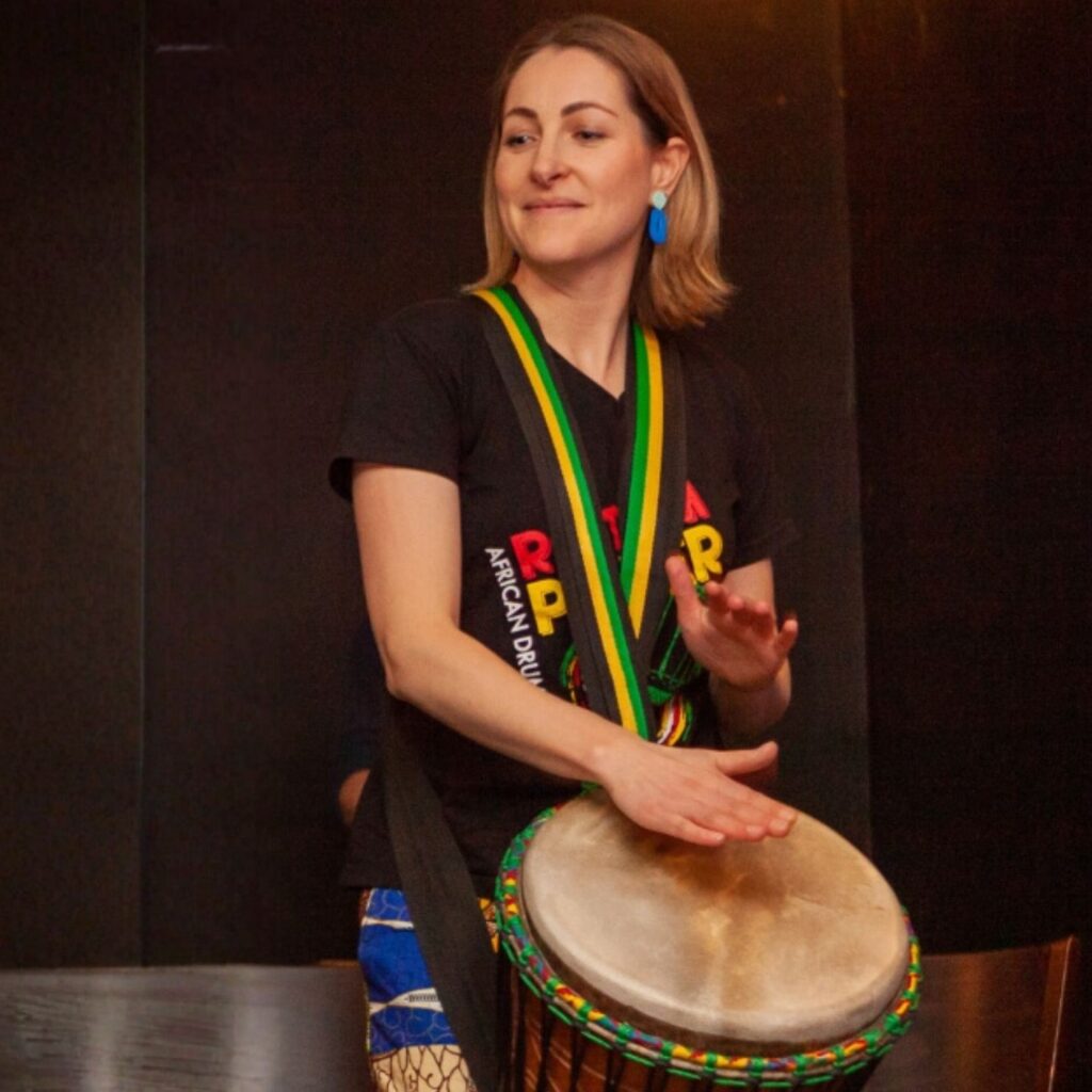 Katrina Brooks facilitator playing djembe