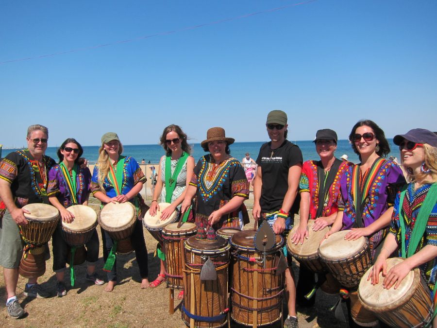 Sessi Sessi community African drumming ensemble performing with drums at an outdoor event