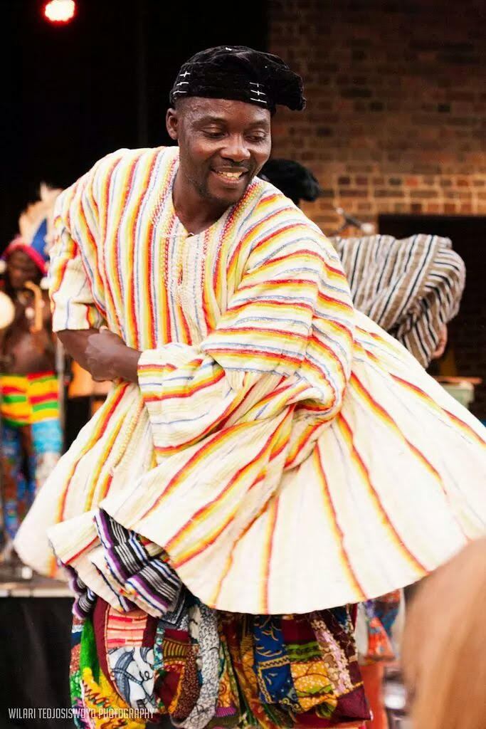 Kofi Nortey, West African singing workshop facilitator, performing in traditional Ghanaian dress