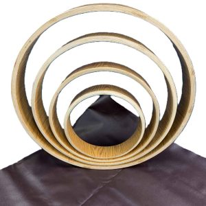 Vegan shamanic frame drum kit with four nested teak and meranti hoops and a rolled synthetic drum head.
